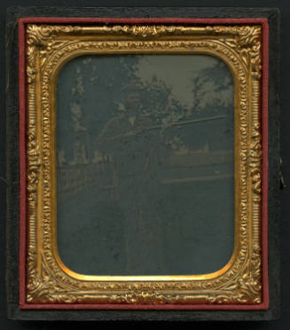 Man Holding a Long Gun