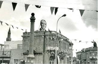 Flags appeared in Ataturk Square on the Turkish side of Nicosia on Feb. 14, 1975 in celebration of the declaration. Huge picture of Ataturk adorns bank building, Cyprus, Turkey