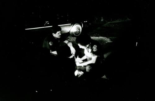 Atlanta police patrolmen checking their map in the headlights of their vehicle during all night curfew, Atlanta, Georgia