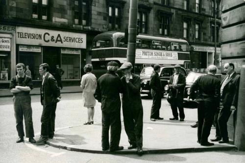 Shipyard workers standing on street, Glasgow, Scotland