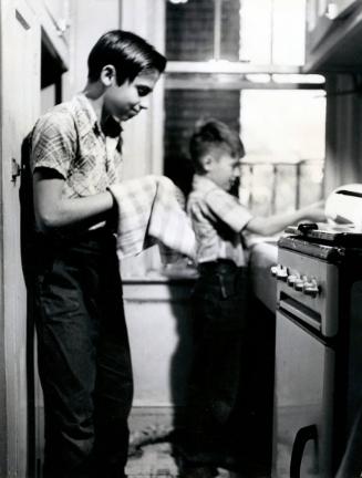 Adoption: Young Immigrant Boy Helping with the Dishes, New York City