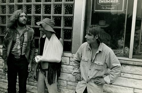 Three Young Men, One With a Sling